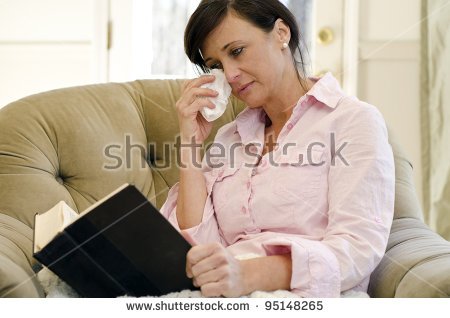 stock-photo-woman-curled-up-in-a-chair-reading-a-book-95148265.jpg