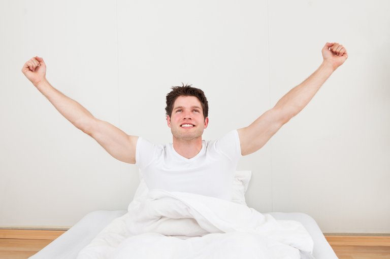 Man-With-Arm-Raised-On-Bed.jpg