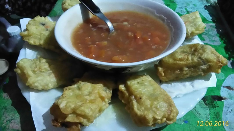 a type of fritters with a red sauce containing vegetables