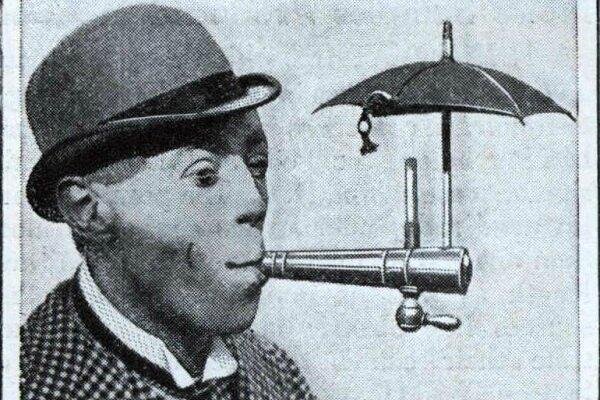 smoke man smoiks metal pipe with tiny umbrella of top.jpg