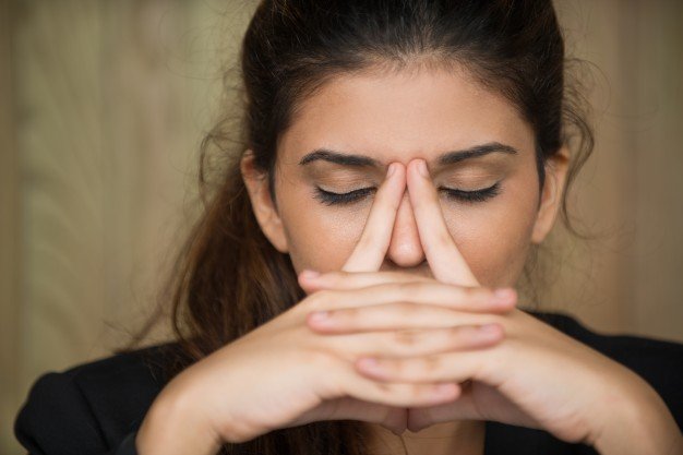 close-up-of-tired-young-woman-rubbing-nose_1262-4804.jpg