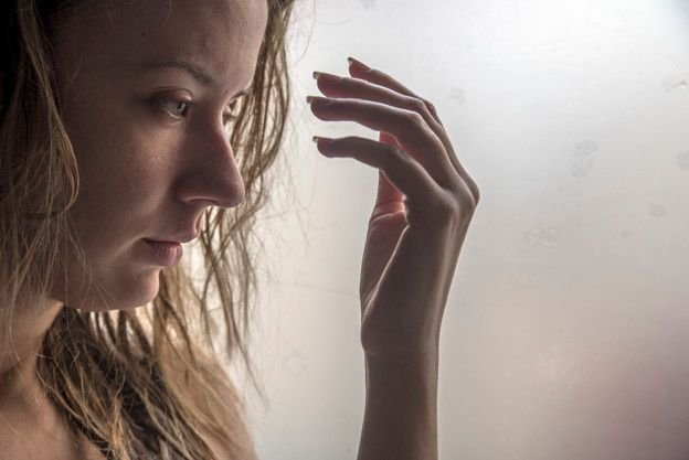 lonely-girl-near-window-thinking-about-something-sad-woman-looking-the-rain-falling-through-a-window-at-home_1391-429.jpg