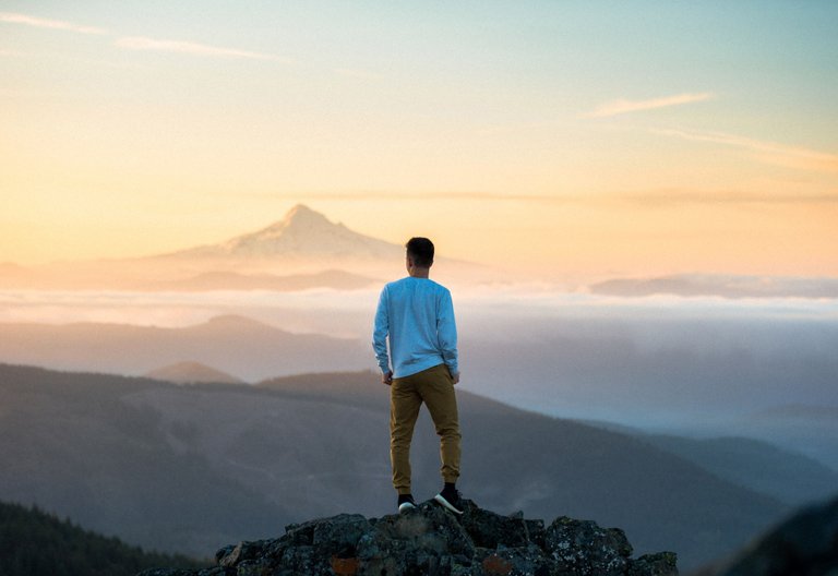 man-standing-on-top-of-mountain.jpg