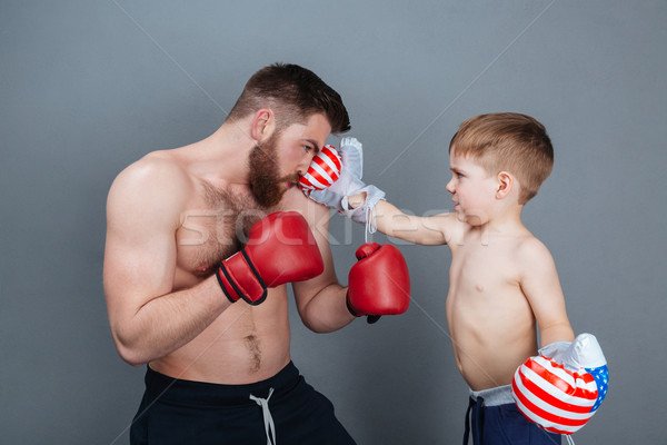 7065760_stock-photo-dad-and-son-playing-using-boxing-gloves-together.jpg