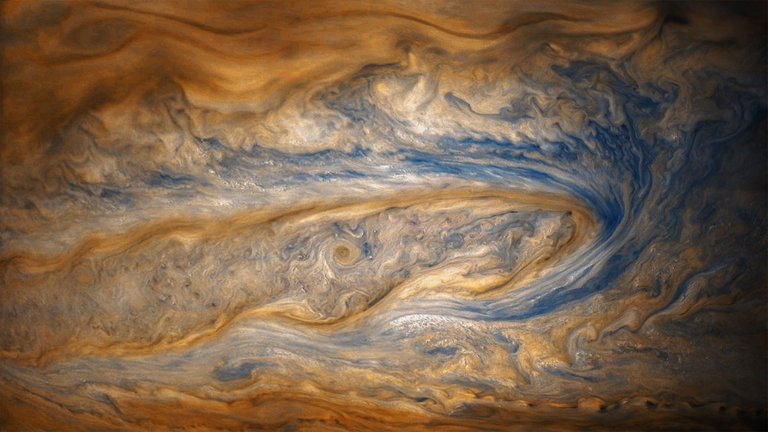 in-this-older-view-of-jupiter-from-junos-eighth-perijove-two-cloud-bands-battle-for-dominance--one-of-which-contains-a-swirling-storm-many-times-larger-than-a-hurricane-on-earth.jpg