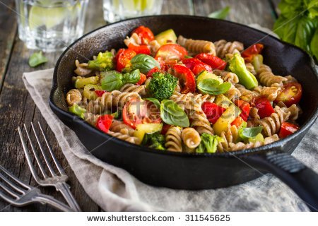 stock-photo-whole-wheat-pasta-with-vegetables-on-cast-iron-pan-311545625.jpg