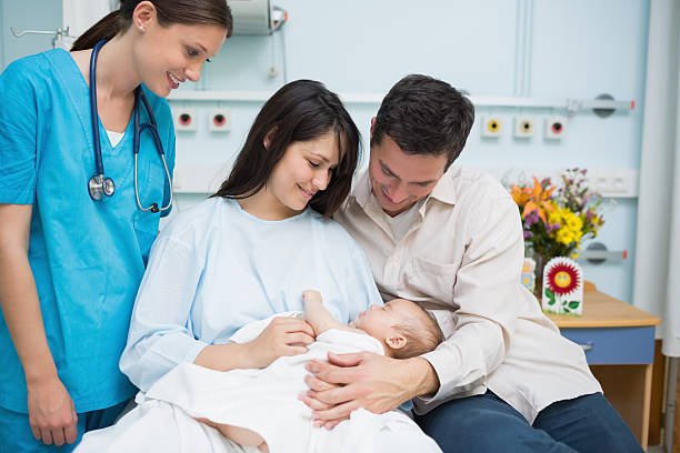 father-and-mother-holding-new-born-baby-with-a-doctor-picture-id462688891.jpeg