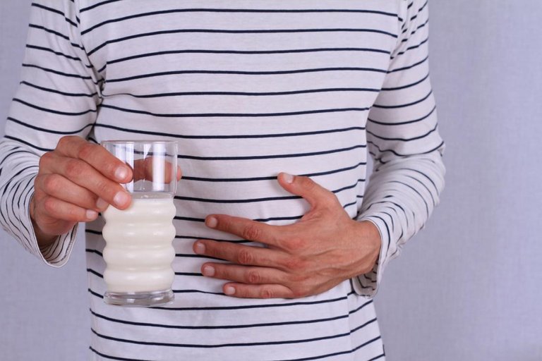 man-clutching-his-stomach-after-drinking-milk.jpg