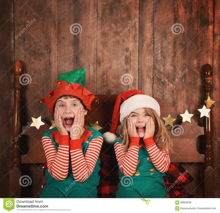 funny-christmas-kids-bed-hats-two-young-children-surprised-excited-sitting-pajamas-wood-walll-use-88826938.jpg