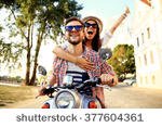 stock-photo-couple-in-love-riding-a-motorbike-handsome-guy-and-young-sexy-woman-travel-young-riders-377604361.jpg