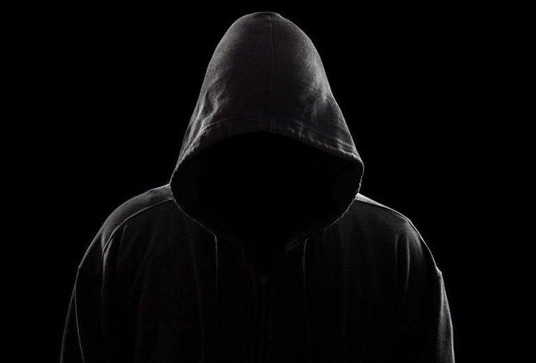 hooded-figure-dark-sinister-hood-against-black.jpg