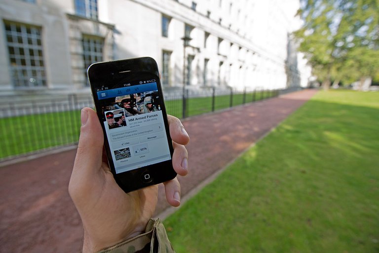 A_serviceman_accesses_social_media_channels_using_a_smart_phone,_outside_MOD_Main_Building_in_London_MOD_45156045.jpg