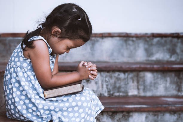 cute-asian-little-girl-closed-her-eyes-and-folded-her-hand-in-prayer-picture-id683912118.jpg