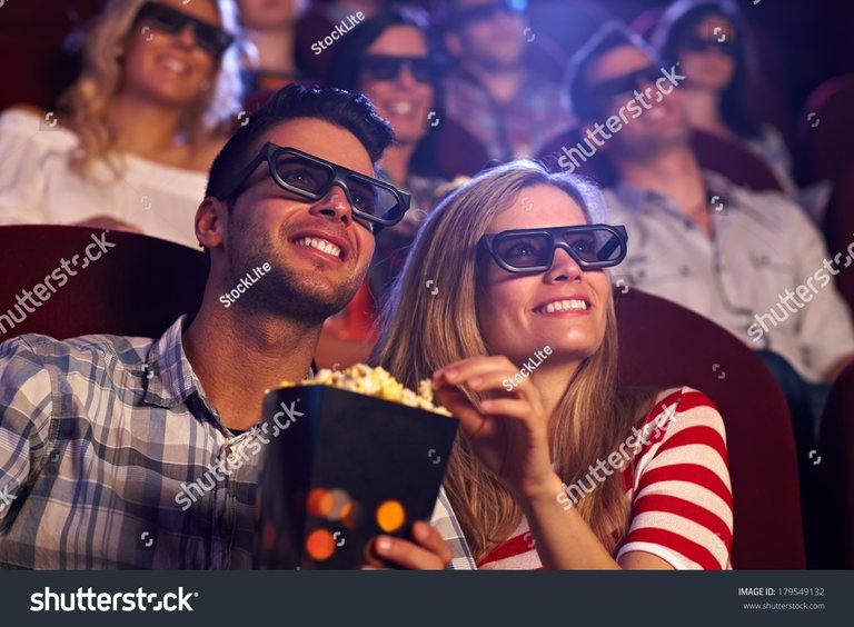 stock-photo-happy-couple-sitting-in-movie-theater-watching-d-movie-eating-popcorn-smiling-179549132.jpg