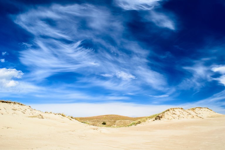 spectacular-cloudy-sky-over-sandy-ground.jpg