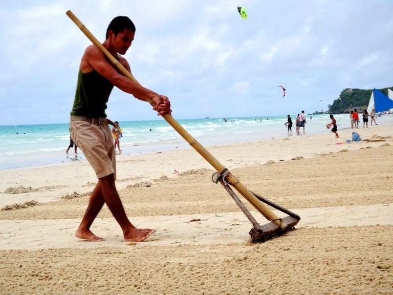 a-local-raking-the-beach-in-boracay.jpg