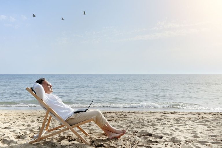 man-with-laptop-computer-relaxing-on-the-beach.jpg