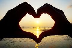 silhouette-hands-heart-two-make-sign-50278175.jpg