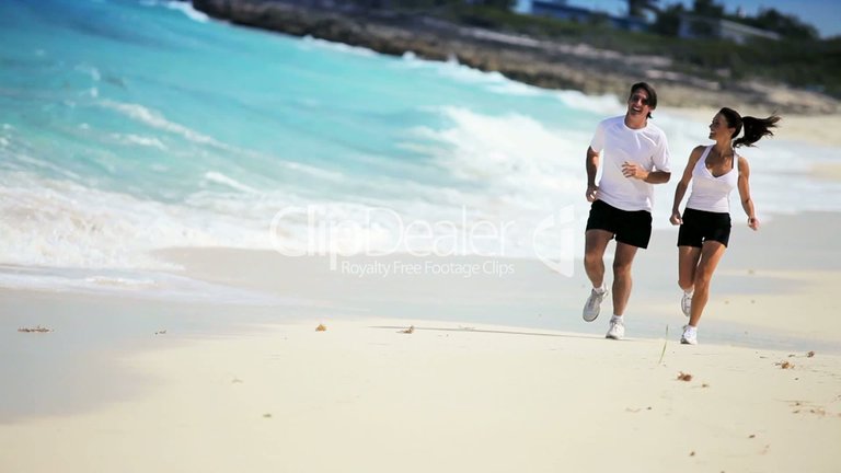 attractive couple jogging along tropical beach high resolution wallpaper.jpg