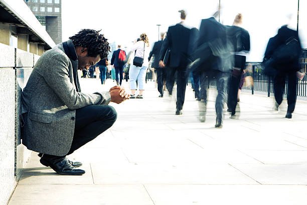 worlds-apart-a-man-begging-the-busy-streets-of-london-picture-id157278469.jpg