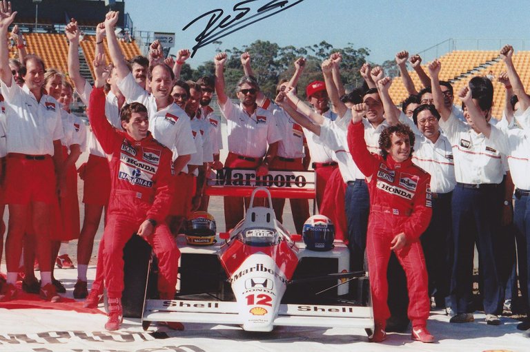 mclaren-honda-world-champion-ayrton-senna-with-his-teammate-alain-prost-and-all-members-of-the-team-staff-12-november-1988-signed-by-dennis.jpg