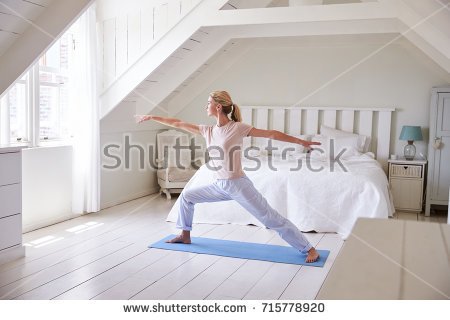 stock-photo-woman-at-home-starting-morning-with-yoga-exercises-in-bedroom-715778920.jpg