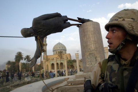 us-marine-corp-assaultman-kirk-dalrymple-watches-as-a-statue-of-iraqs-president-saddam-hussein-falls-in-central-baghdad-april-9-2003-us-troops-pulled-down-a-20-foot-six-metre-high-statue-of-president-saddam-.jpg