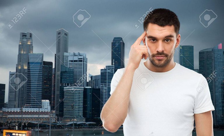advertisement-idea-business-mind-and-people-concept-man-pointing-finger-to-his-temple-over-evening-s.jpg