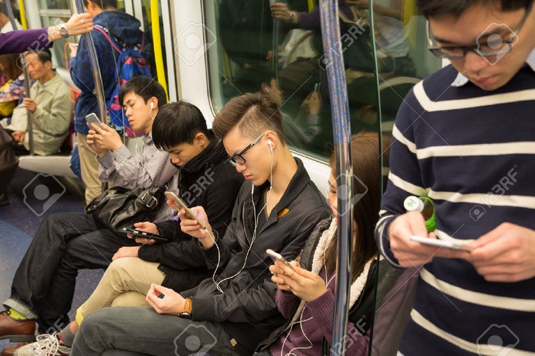 42697247-HONG-KONG-CIRCA-FEBRUARY-2015-People-traveling-in-the-subway-and-actively-use-smartphones-Metro-aka--Stock-Photo.jpg