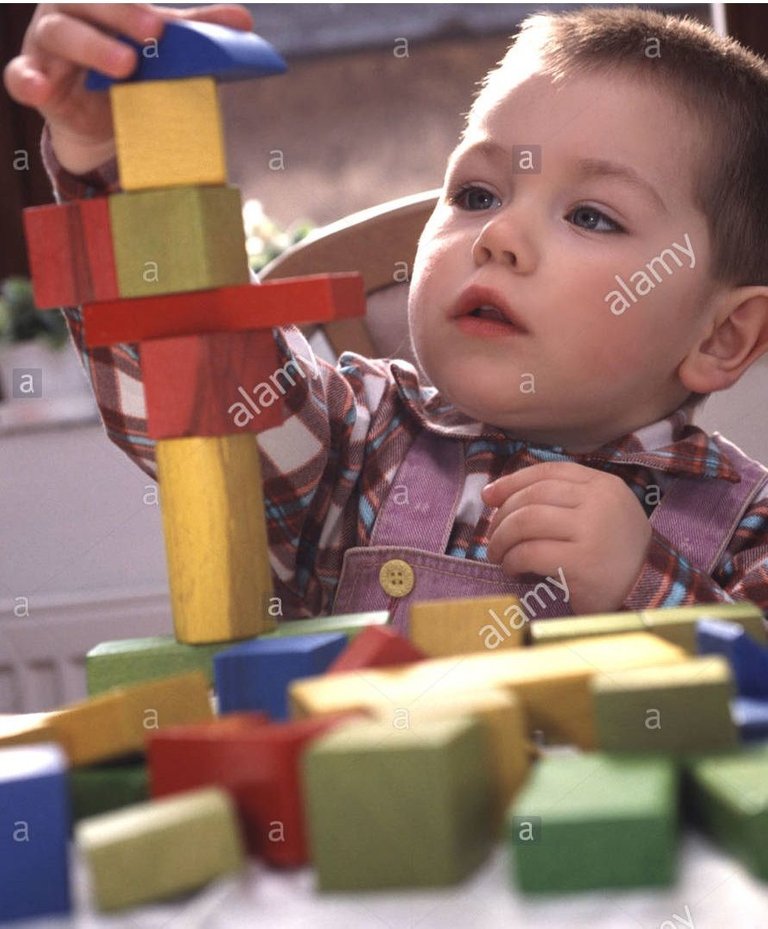 boy-playing-with-dice-AJD8CE.jpg