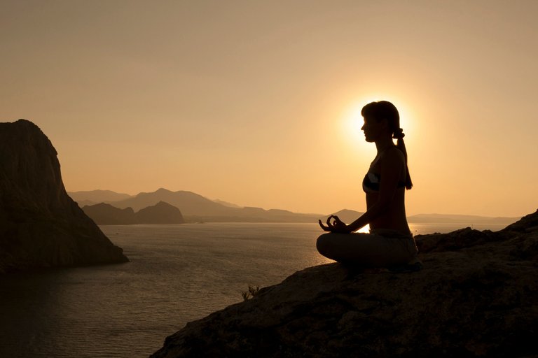 woman-meditating-on-mountain.jpg