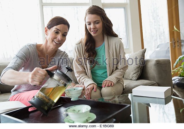 mother-and-daughter-pouring-tea-in-living-room-e1bg69.jpg