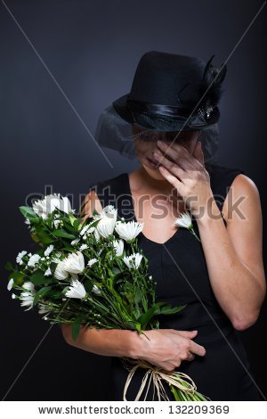 stock-photo-sad-widow-crying-at-husband-s-funeral-132209369.jpg