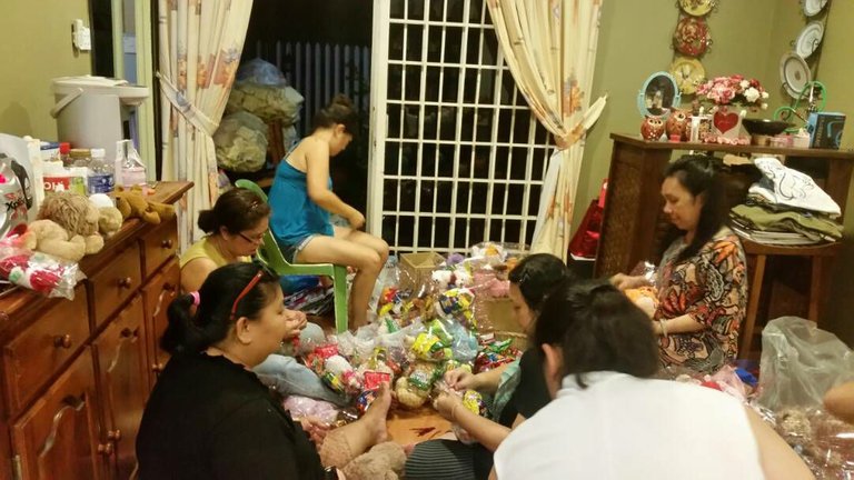 Maria would gather her relatives and friends to pack goody bags for the children in the rural area as Christmas present.jpg