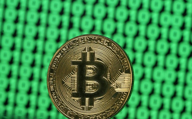 file-photo-a-token-of-the-virtual-currency-bitcoin-is-seen-placed-on-a-monitor-that-displays-binary-digits-in-this-illustration-picture-december-8-2017-reuters-dado-ruvic-illustration-file-photo.jpg