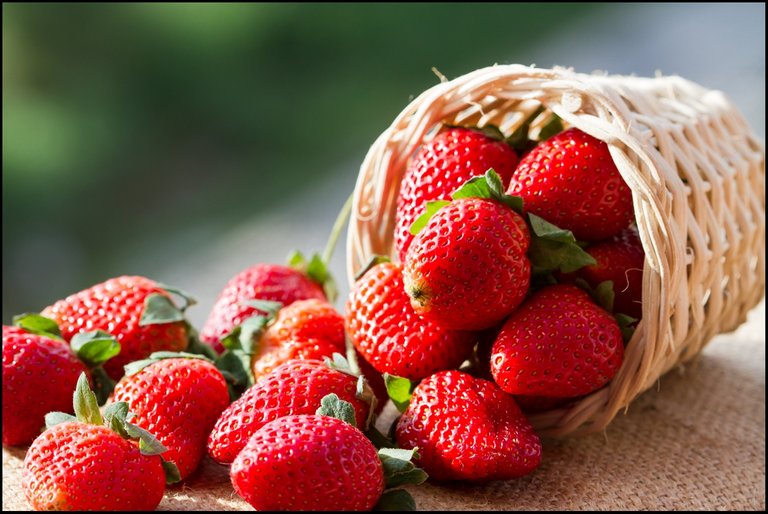 A-small-basket-full-of-strawberries-in-natural-background.jpg