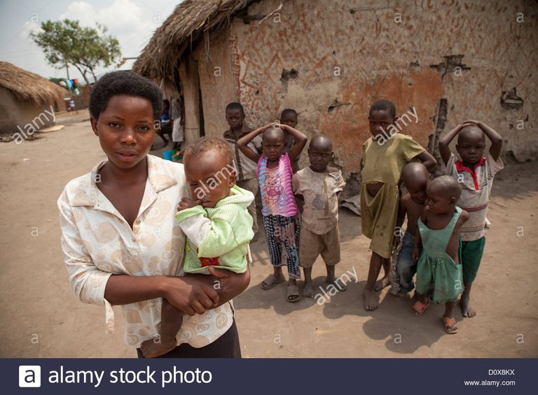 a-young-mother-holds-her-child-outside-her-house-in-kasese-uganda-D0X8KX.jpg