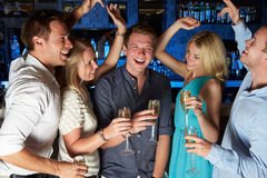 group-friends-enjoying-glass-champagne-bar-smiling-laughing-32062041.jpg