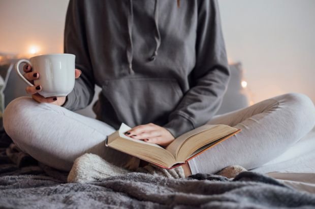 woman-reading-book-and-drinking-tea-on-bed.jpg