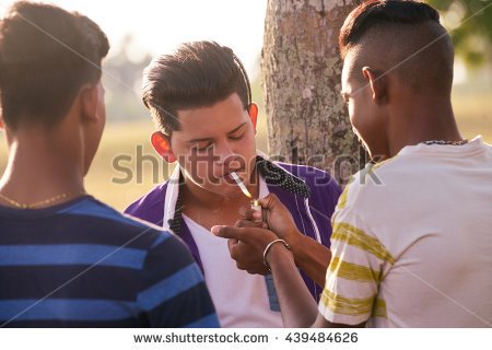 stock-photo-kids-smoking-cigarette-in-park-concept-of-health-problems-and-social-issues-between-young-people-439484626.jpg