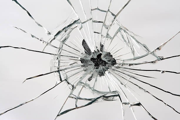 broken-mirror-with-central-hole-from-impact-picture-id151553542.jpeg