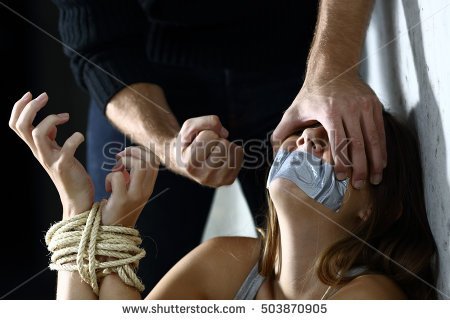 stock-photo-terrified-kidnapped-woman-being-threatened-by-the-fist-of-a-kidnapper-503870905.jpg