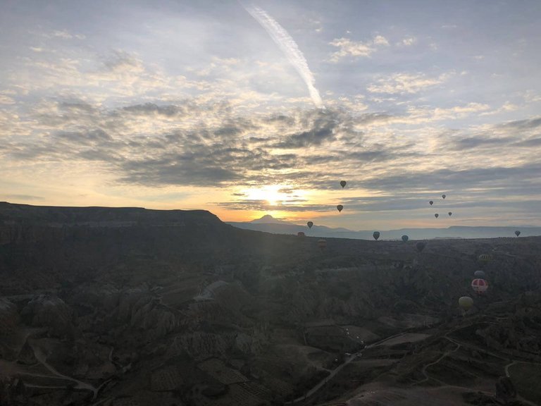 You enjoy a stunning view of the valley as your balloon flirts with the clouds