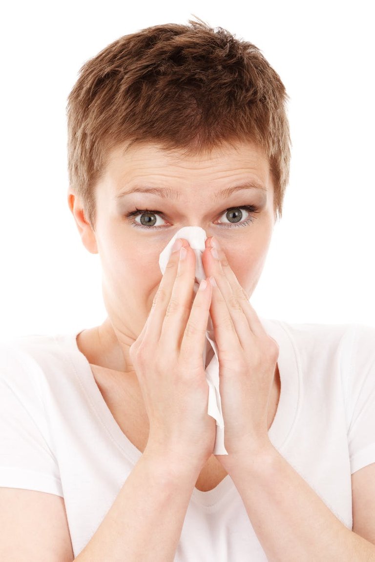 short red hair woman blowing her nose