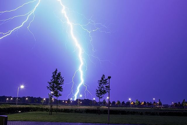 Lightning as an example of plasma present at Earth's surface: Typically, lightning discharges 30 kiloamperes at up to 100 megavolts, and emits radio waves, light, X- and even gamma rays.[34] Plasma temperatures can approach 30000 K and electron densities may exceed 1024 m−3.