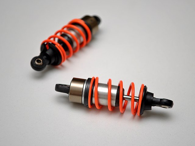 Miniature oil filled Coilover shock components for scale cars.