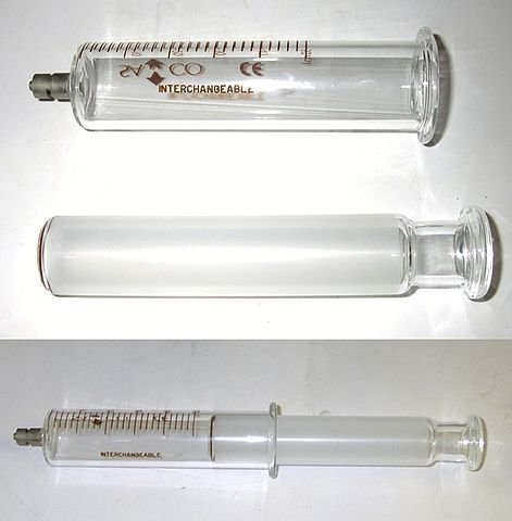 A gas syringe showing its components separated and assembled