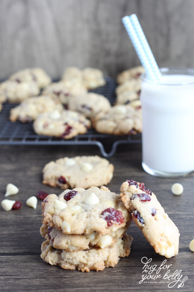 cookies on wooden background next to glass of milk