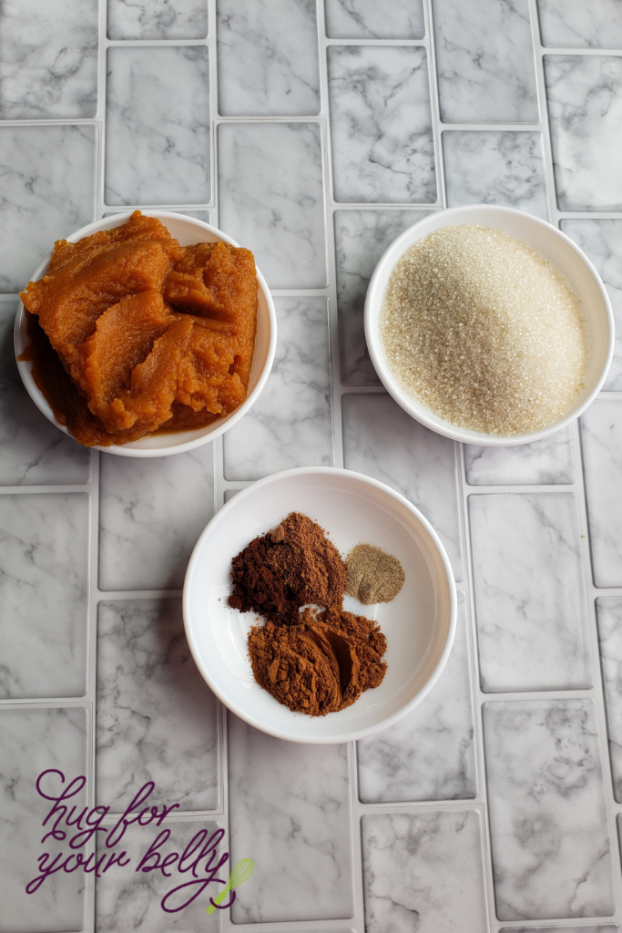 pumpkin, sugar, and spices in white bowls