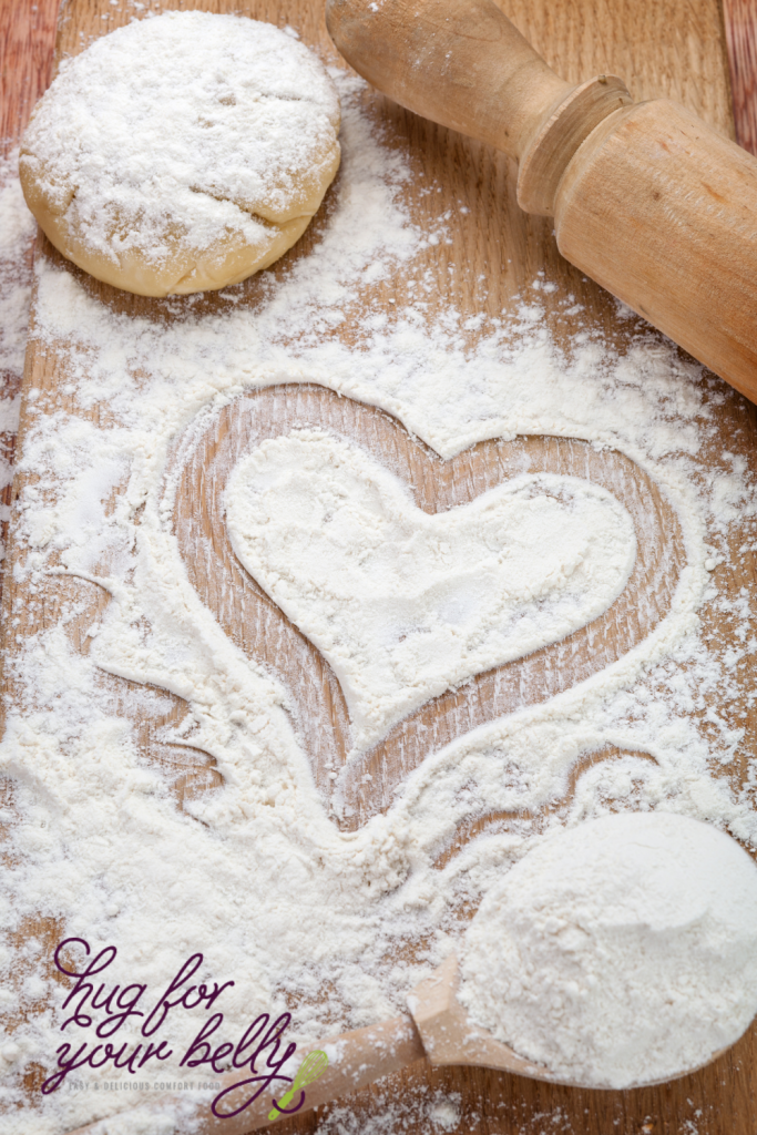 heart drawn into flour on wooden board